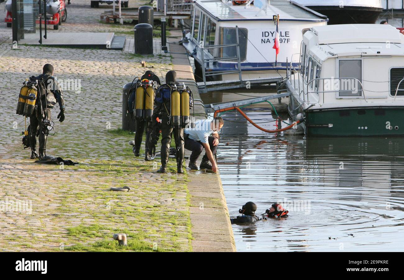 Policemen unload an unidentified dead body from a boat on the Saint Felix canal in Nantes, western France, December 12, 2006. Police were searching for Tunisian worker Taoufik El-Amri who was last seen leaving a bar on November 22. Three French police officers were arrested yesterday after the body of a man of Arab origin was found floating in a canal in Nantes. The officers had already been questioned about a 33-year-old Tunisian, Taoufik el-Amri, who disappeared after they interrogated him on 22 November. The three said they had let the man go soon after arresting him as he left a bar. Howev Stock Photo