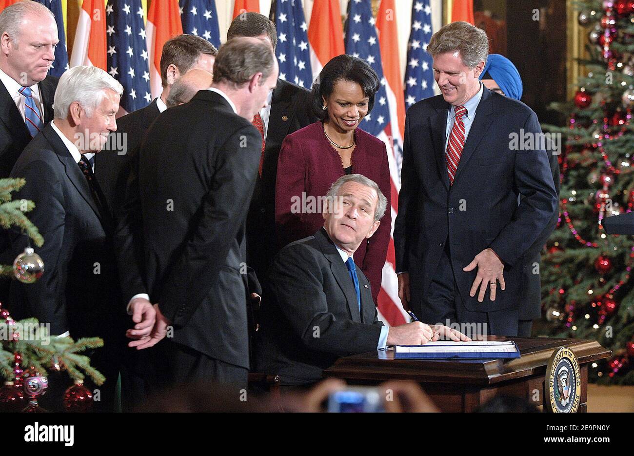 U.S. President George W. Bush signs the United States-India Peaceful Atomic Energy Cooperation Act into law as Senate Republican Leader Bill Frist (R-TN), Secretary of State Condoleezza Rice, Rep. Joseph Crowley (D-NY), Sen. George Allen (R-VA), Rep. Frank Pallone (D-NJ), and Ambassador Raminder Jassal, Charge d'affaires of India, look on during a ceremony December 18, 2006 in the East Room of the White House in Washington, DC. The act allowed civilian nuclear trade with India which was prohibited in the last 30 years.Photo by Olivier Douliery/ABACAPRESS.COM Stock Photo