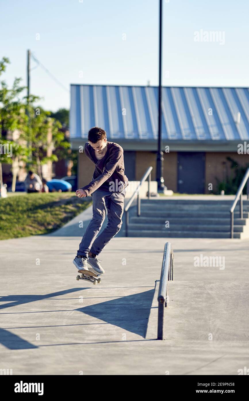 Backside flip over handrail in skatepark, Montreal, Quebec, Canada
