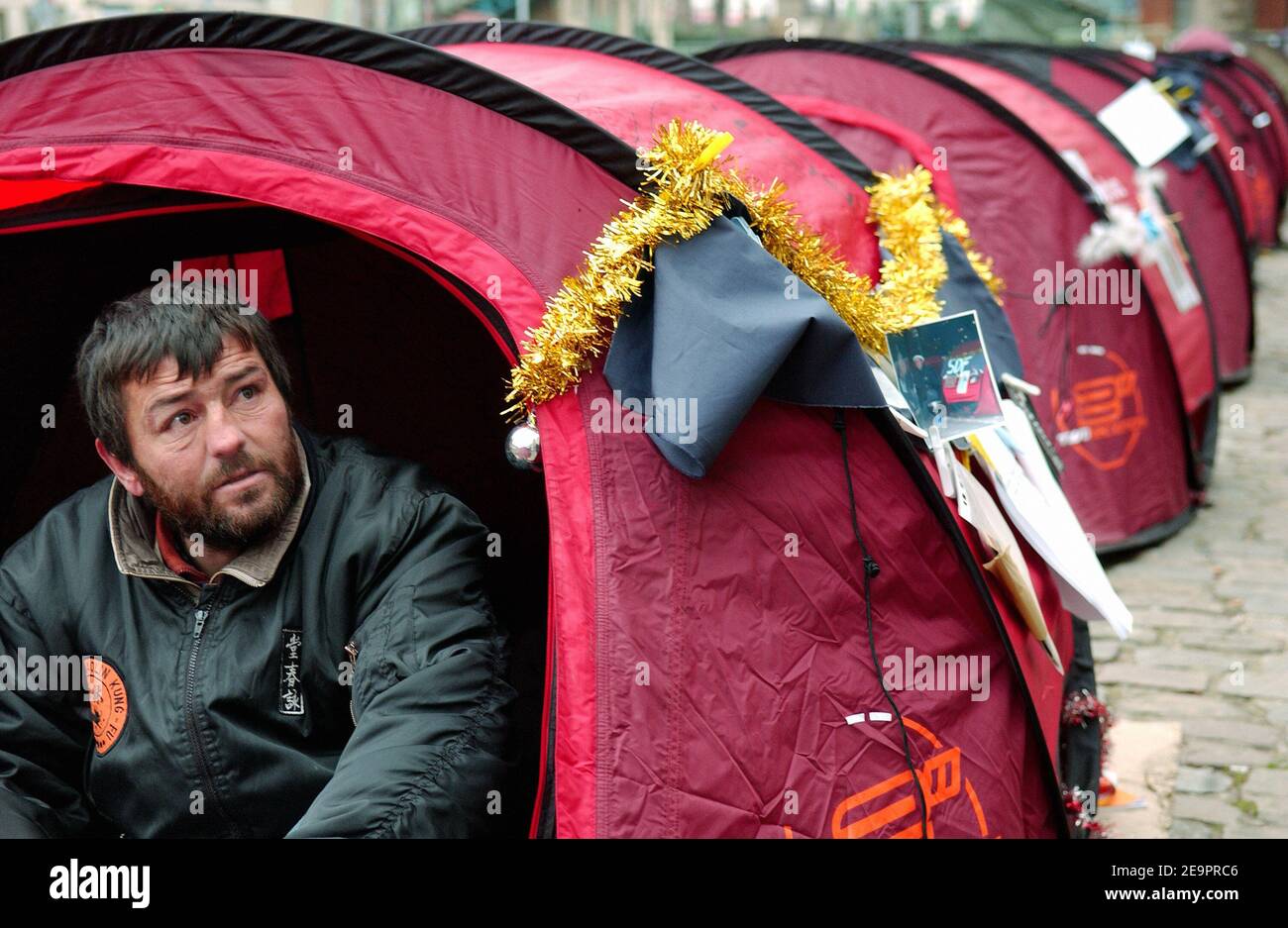 A homeless man sits in a tent along the Canal Saint Martin in Paris,  France, December 28, 2006. The French association 'Enfants de Don  Quichotte' (Children of Don Quichotte) set up the