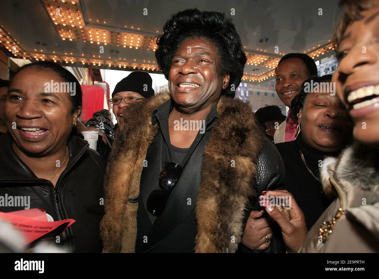 James Brown impersonator and fans line up outside the Apollo Theater to view James Brown's casket in New York 28 December 2006. Brown, 73, who died of congestive heart failure on Christmas Day, received a send-off befitting the music royalty, his white casket pulled by a horse-drawn carriage. Photo by Gerald Holubowicz/ABACAPRESS.COM Stock Photo