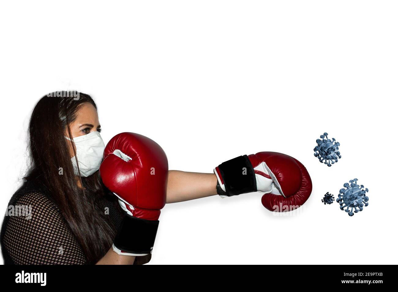 wearing a mask Mexican woman fighting with boxing gloves the disease covid 19 Stock Photo