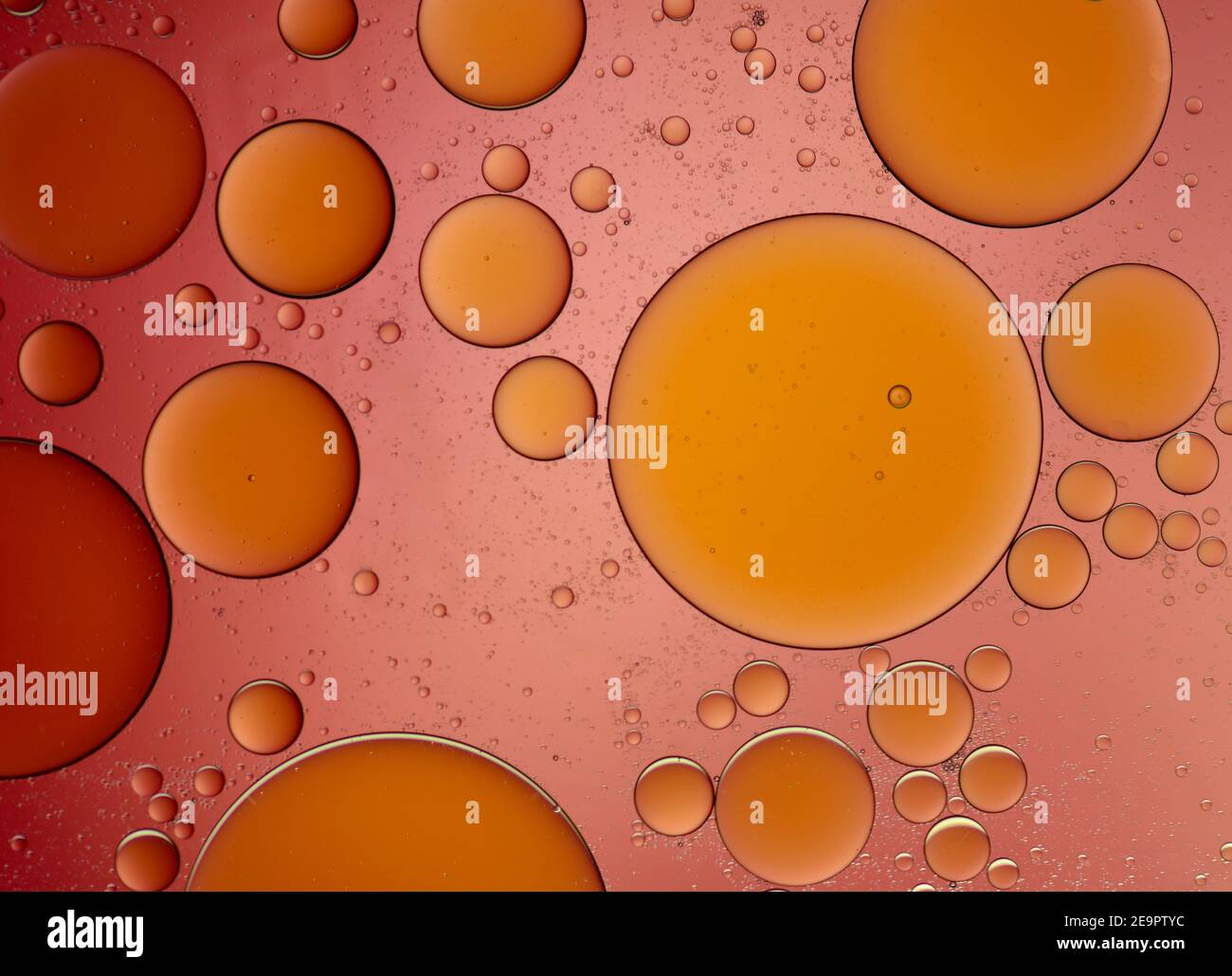 Olive oil drops suspended in water with colorful backgrounds Stock