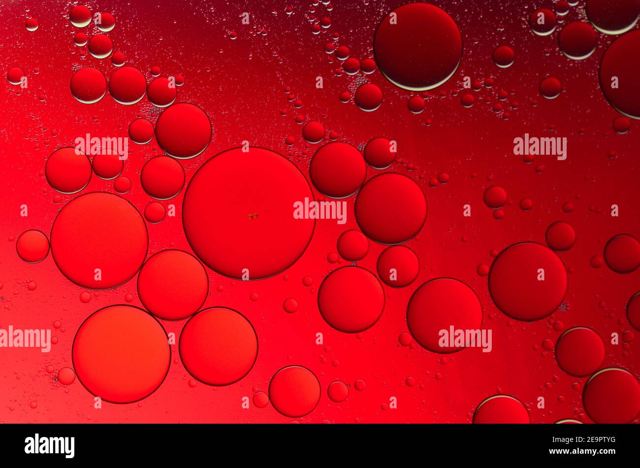 Olive oil drops suspended in water with colorful backgrounds Stock