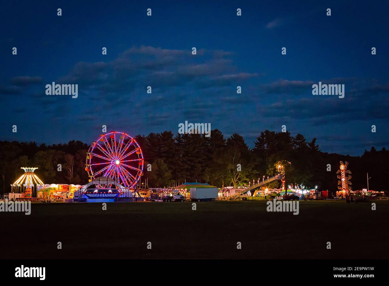 Country Fair Amusement Park Rides Ferris Wheel Nighttime Panoramic Stock Photo