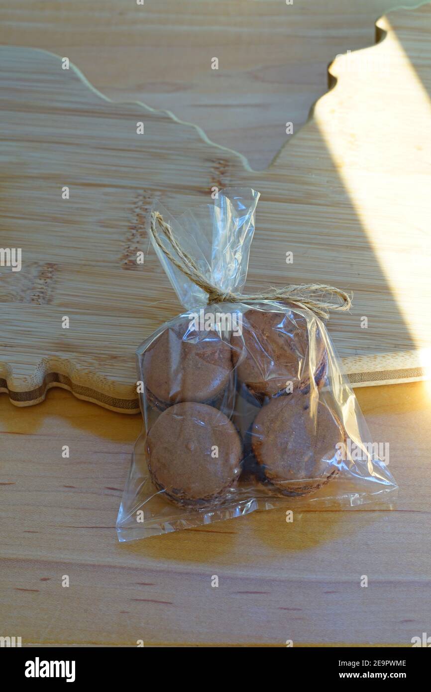 Small cellophane gift bag with four homemade Chocolate cocoa macaron  cookies filled with chocolate hazelnut spread Stock Photo - Alamy