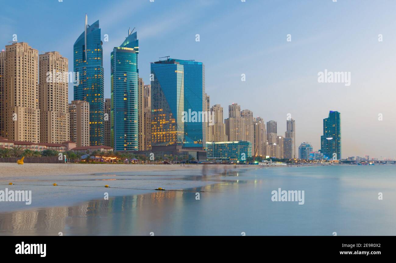 Dubai - The evening skyline of Marina hotels from beach. Stock Photo