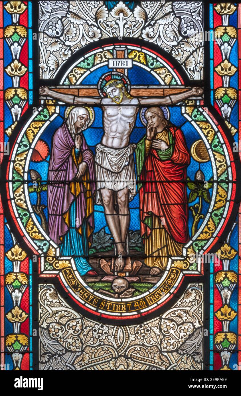VIENNA, AUSTIRA - OCTOBER 22, 2020: The Crucifixion on the stained glass in  in church Pfarrkirche Kaisermühlen Stock Photo