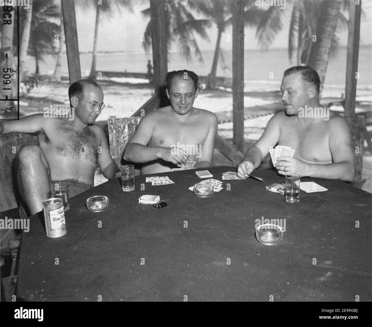 Mr J P Pflueger, Jr, LT V H Dower and CDR O H Marix playing a game of gin-rummy, Bikini Island, 1947 (DONALDSON 177). Stock Photo