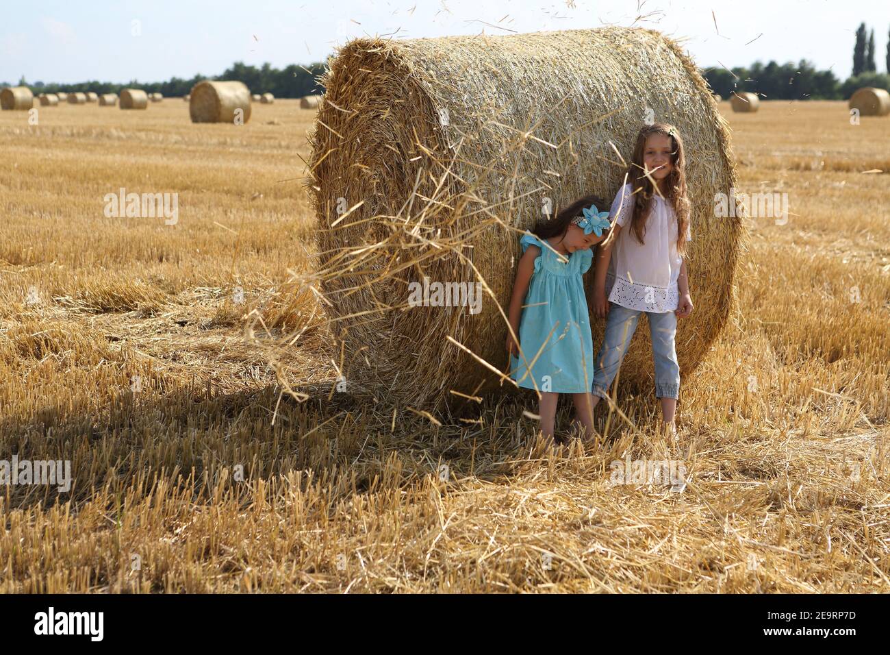 Two little girls playing in a wheat field Stock Photo - Alamy