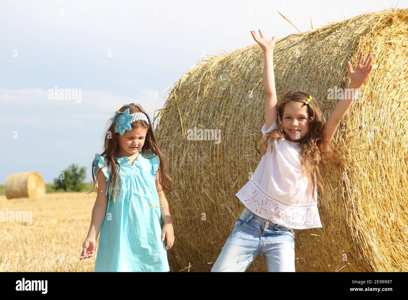 Two little girls playing in a wheat field Stock Photo - Alamy