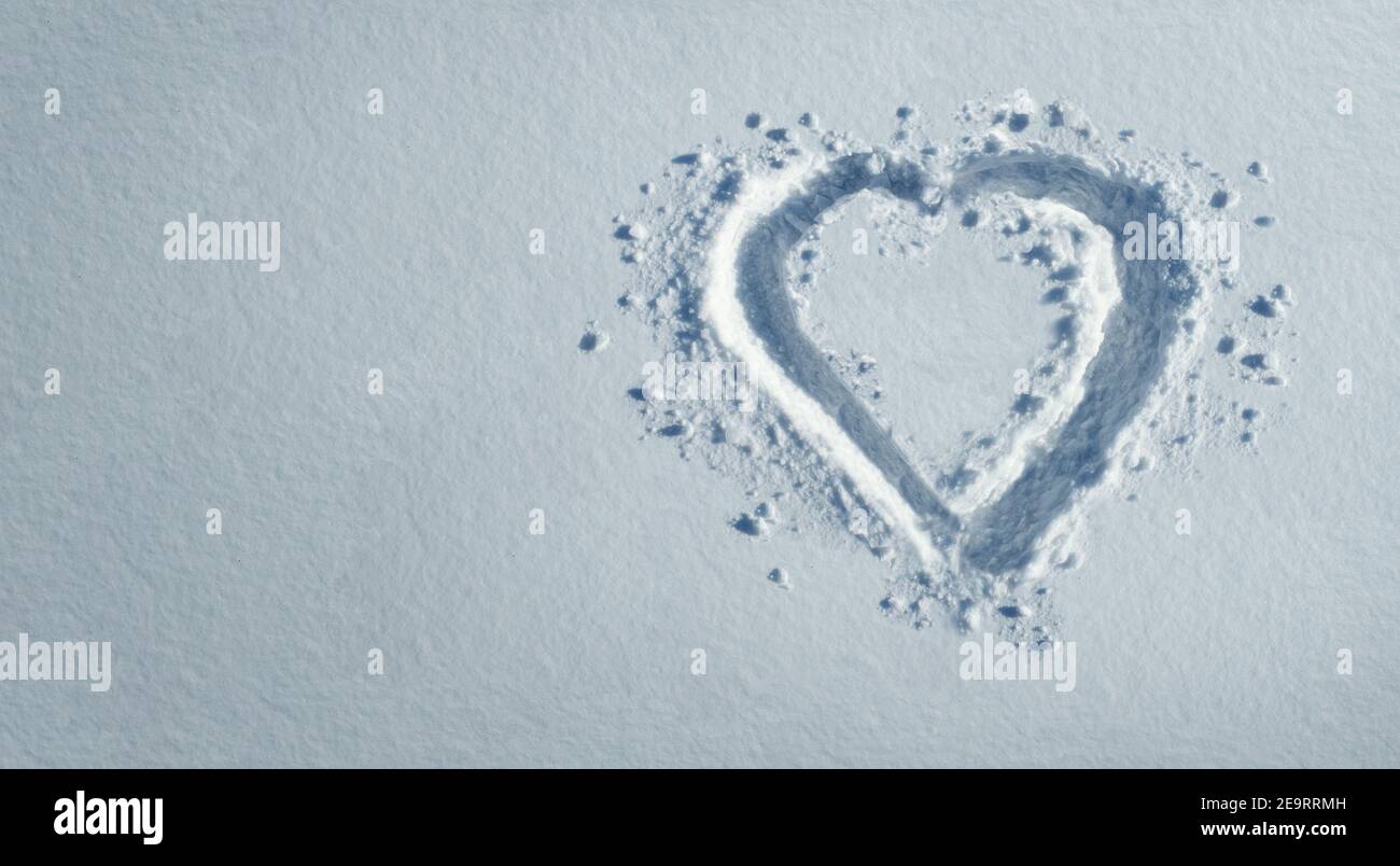 Snow heart and winter love symbol as a romance shape greetings with copy space background. Stock Photo