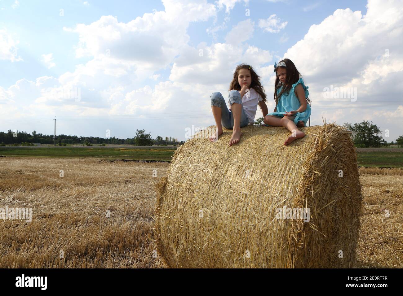 Two little girls playing in a wheat field Stock Photo - Alamy