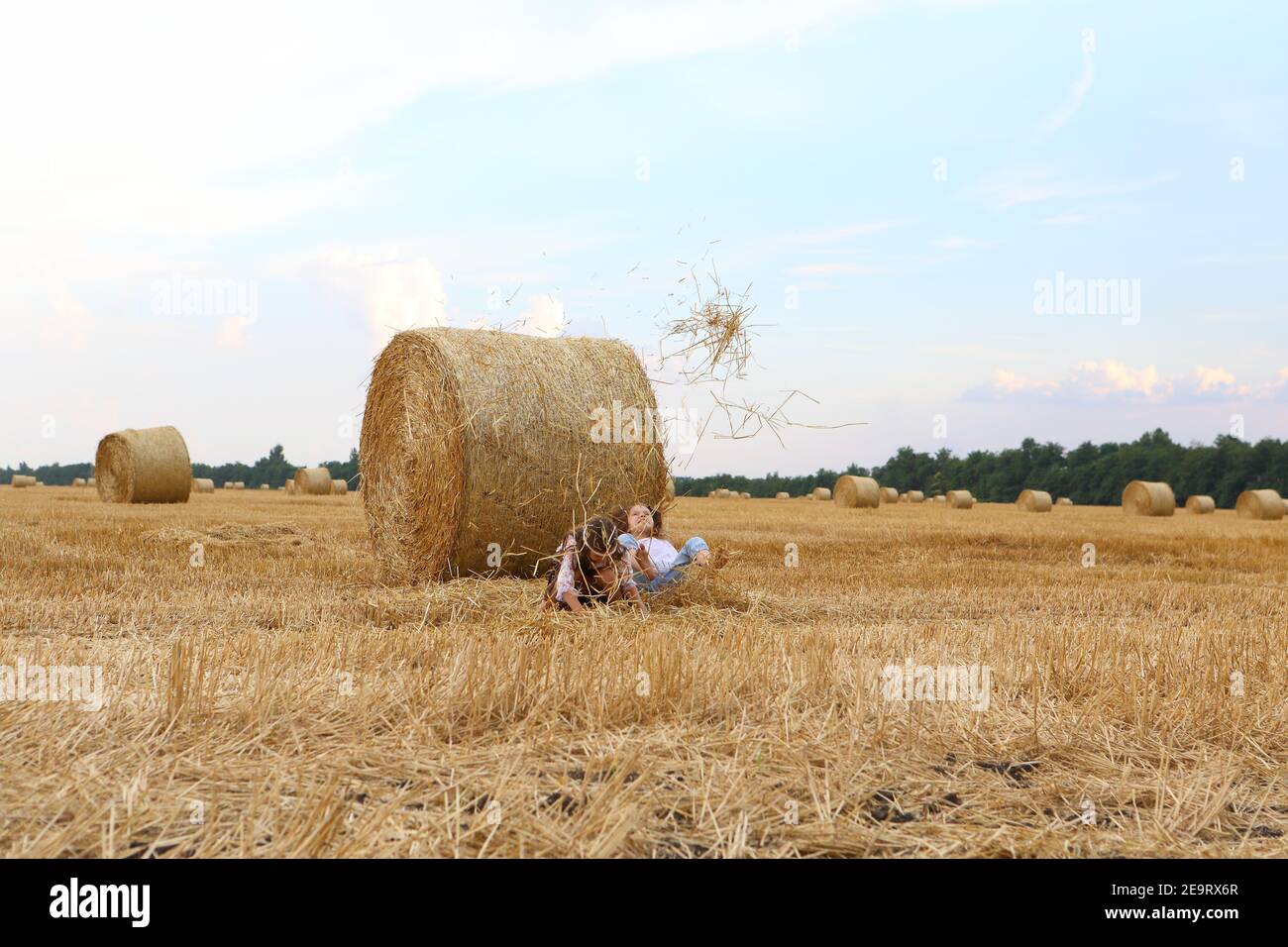 Two little girls playing in a wheat field Stock Photo - Alamy