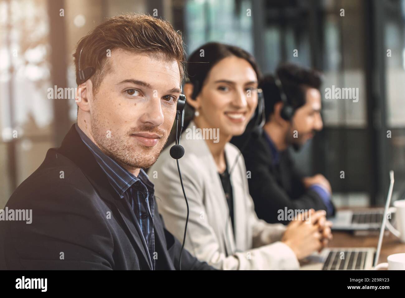 Operator teamwork happy smile, Business call center help desk service team working in office. Stock Photo