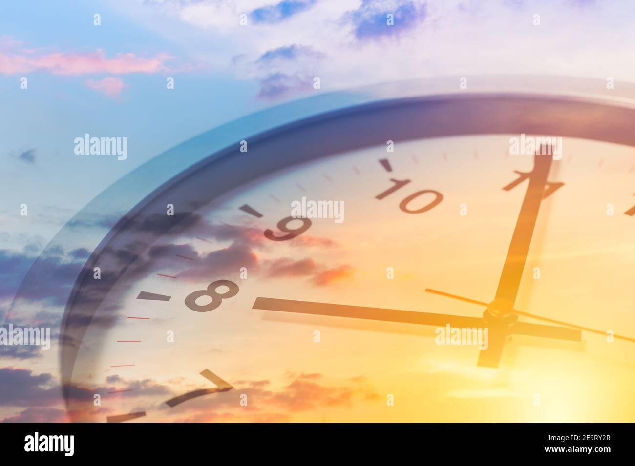 Clock face overlay with beautiful sunrise sky for good times working morning a new day concept. Stock Photo