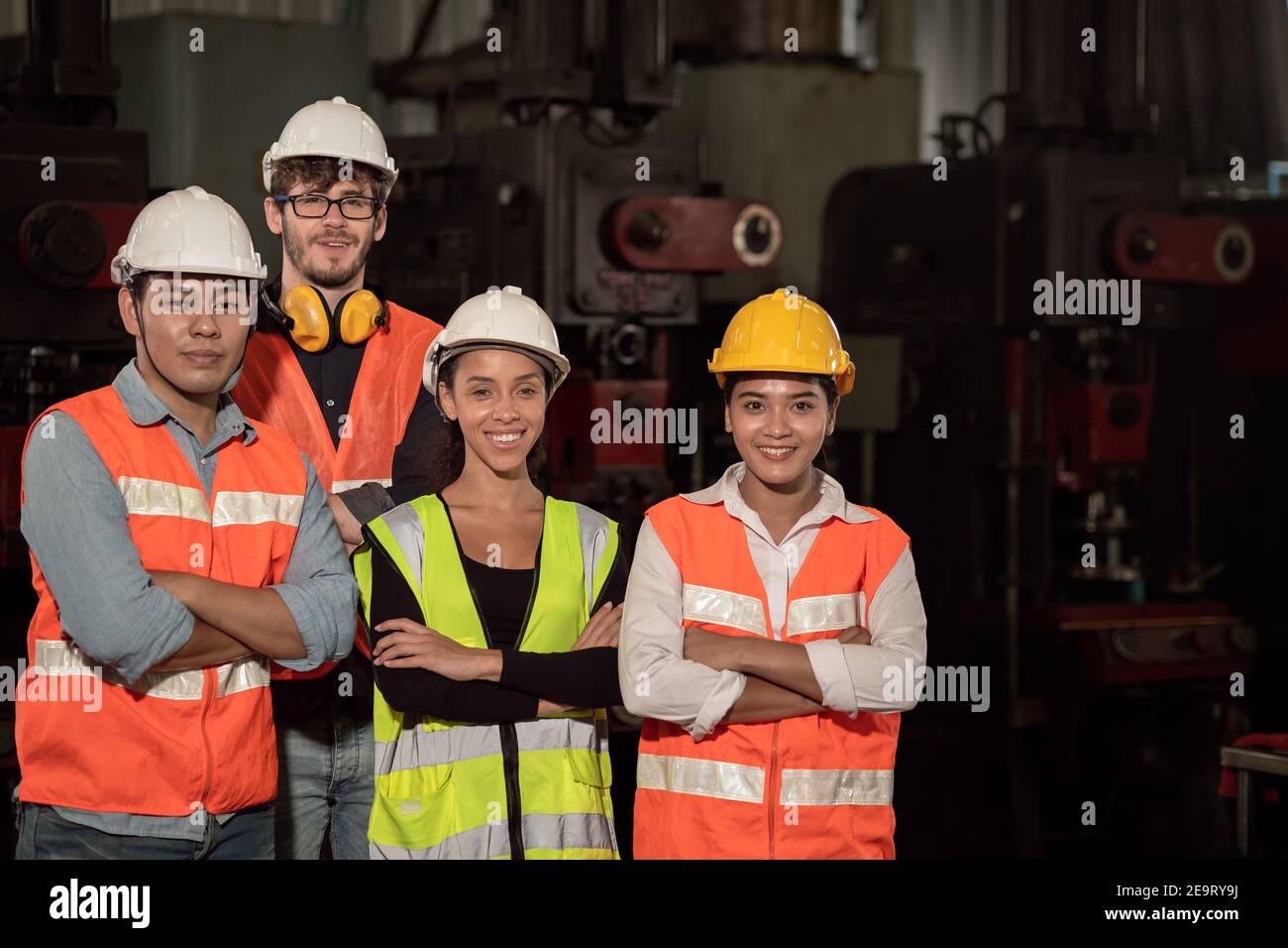 Group of Team Worker mix race  enjoy working in heavy factory standing together happy smiling Stock Photo