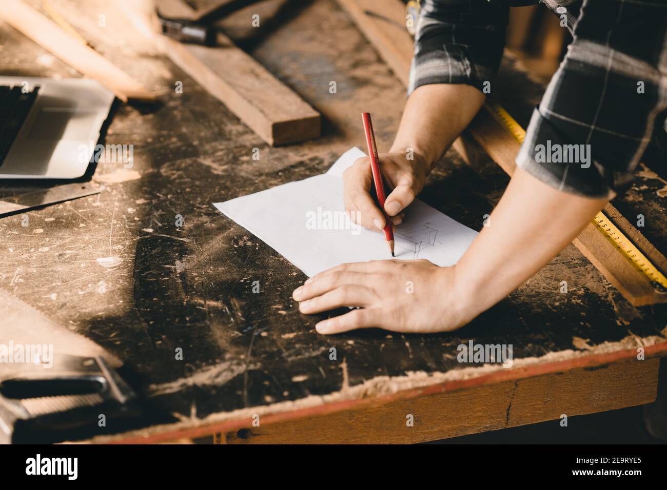 Carpenter hand drawing sketch design dream wooden furniture in paper in ...