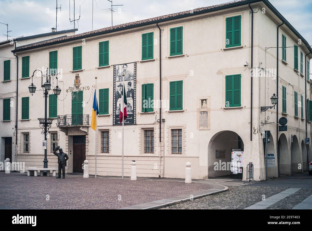 Brescello, Italy - January 1 2014: Town Hall called Municipio with the Statue of Mayor Peppone, a fictional Character from the Don Camillo Movies and Stock Photo