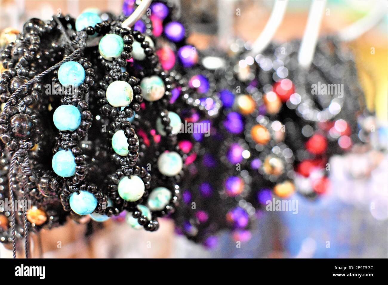 Bead bracelets of different colors being sold at a fashion accessory shop Stock Photo
