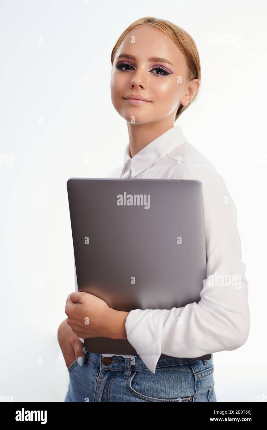 Cheerful girl holding laptop portrait isolated on white studio background Stock Photo