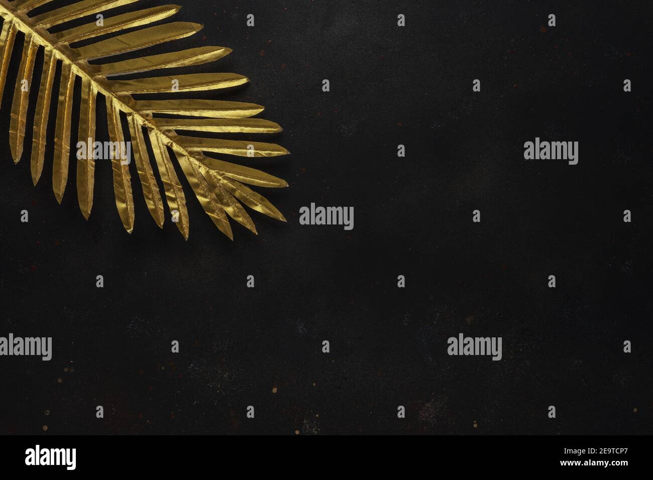 Creative layout with gold tropical palm leaves on black background ...
