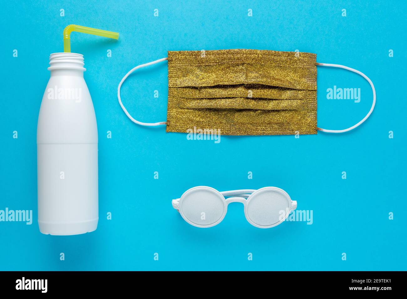 Summer beach layout with sunglasses, white bottle and medical mask. Minimal Coronavirus outbreak. Lockdown concept. Stock Photo