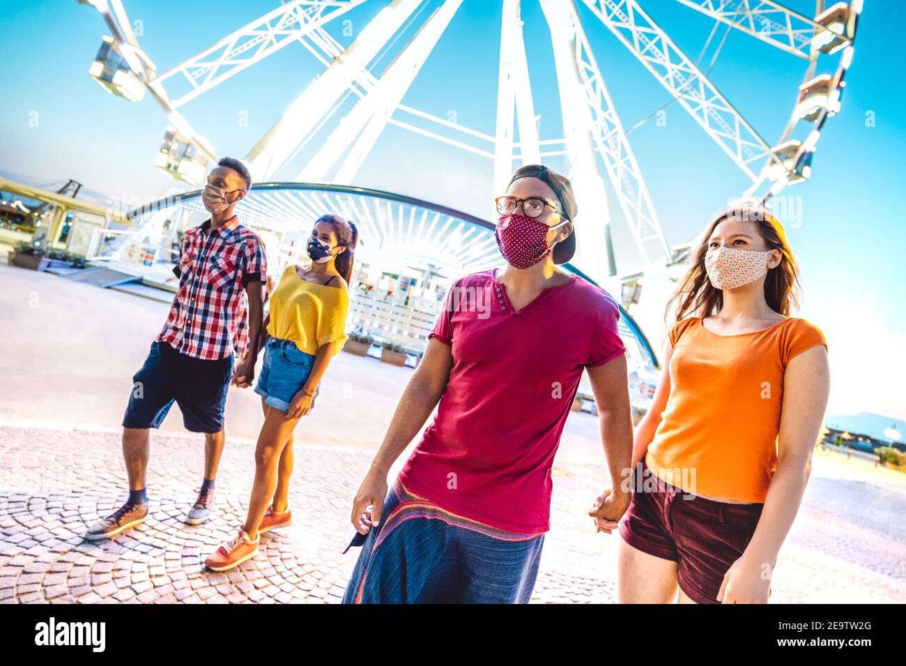 Multiracial couples walking with face masks after lockdown reopening New normal lifestyle