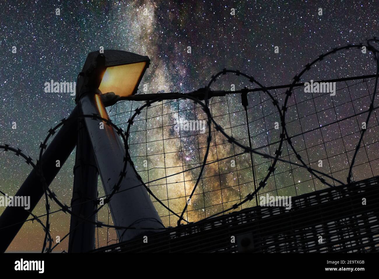 Spotlight and barbed wire to protect private property from unautorised