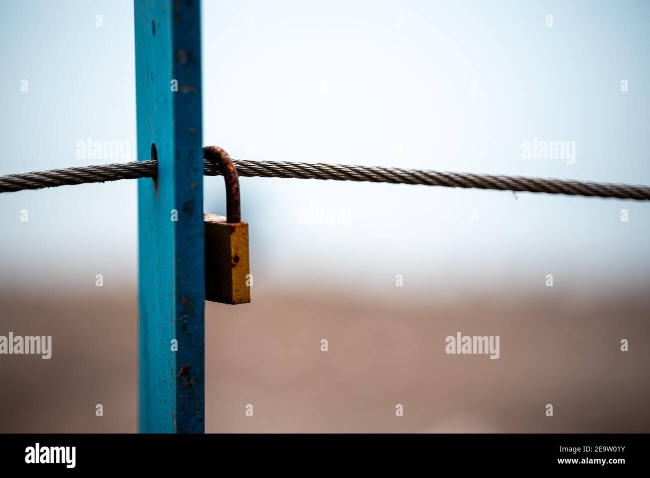 Some rusty padlocks on a steel cable as a symbol of  eternal love - This padlock is a classic couple  tradition (lovelock) Stock Photo