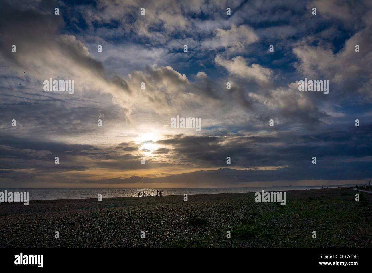 Fishermen on Shoreham Beach in the late afternoon. Stock Photo