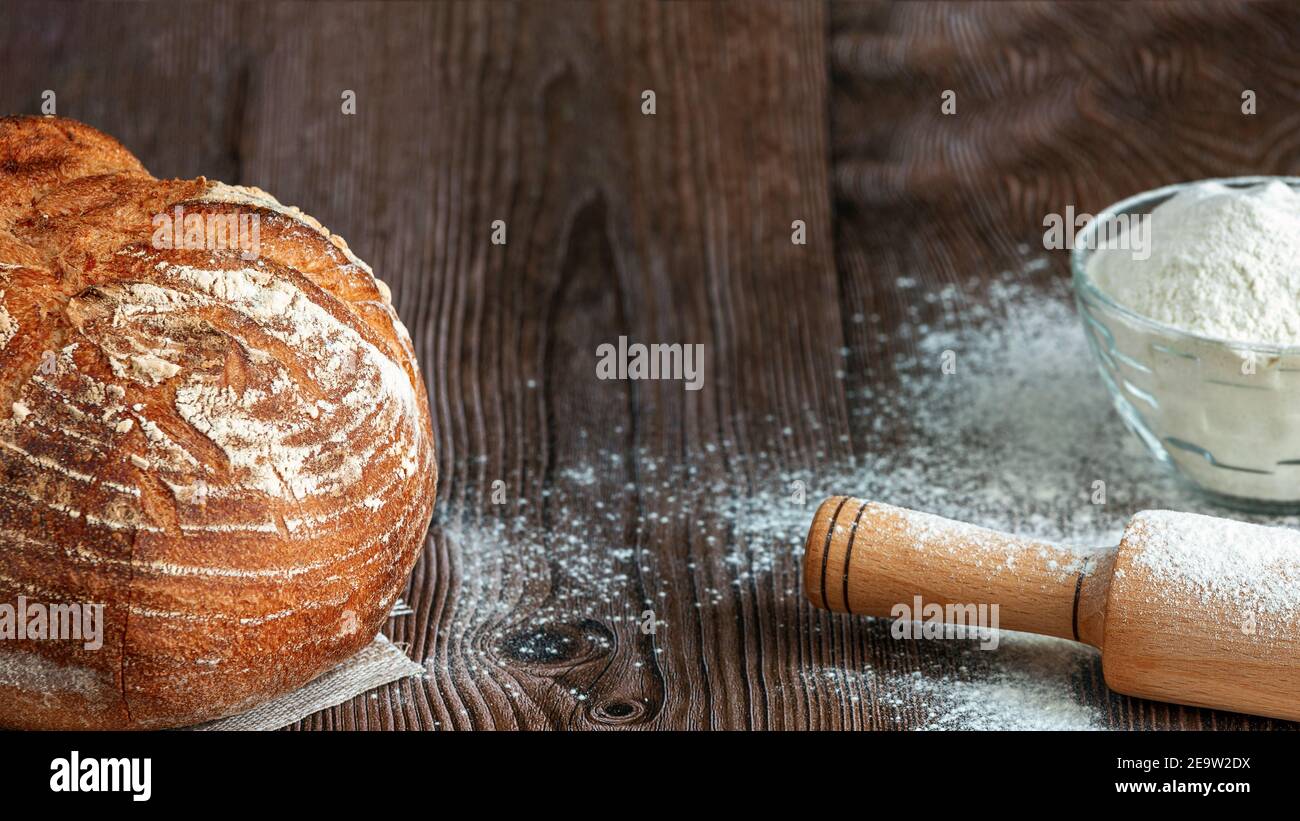 Close up of traditional sourdough bread on a rustic wooden background. Concept of traditional leavened bread baking methods. Healthy food Stock Photo