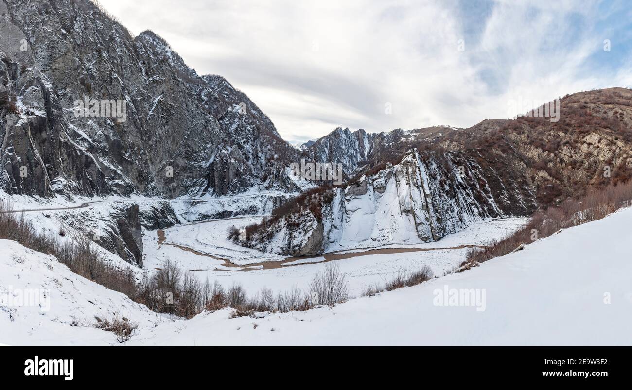 Winter mountain landscape with road and river Stock Photo - Alamy