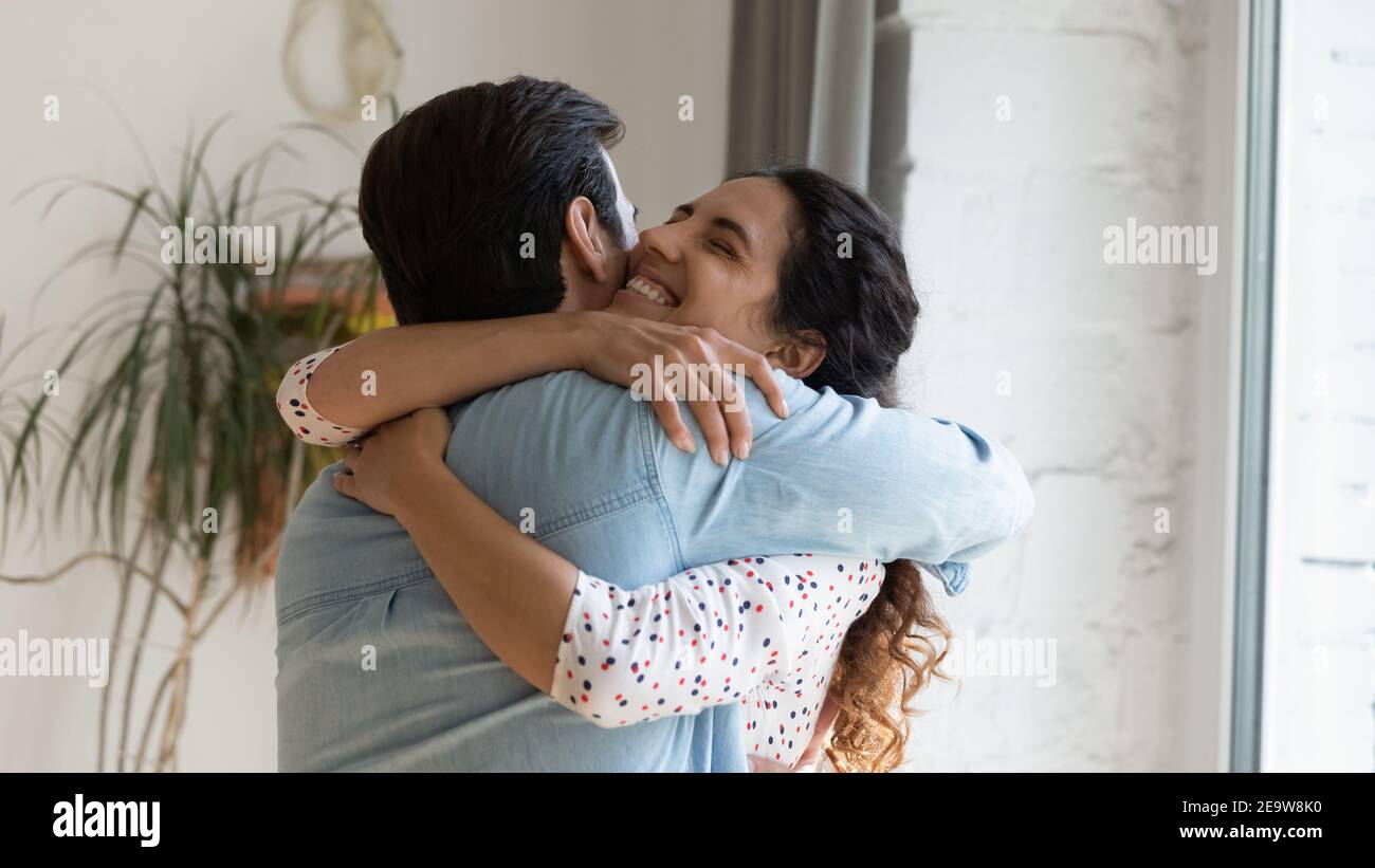 Excited wife holding beloved husband in arms grateful for support Stock Photo