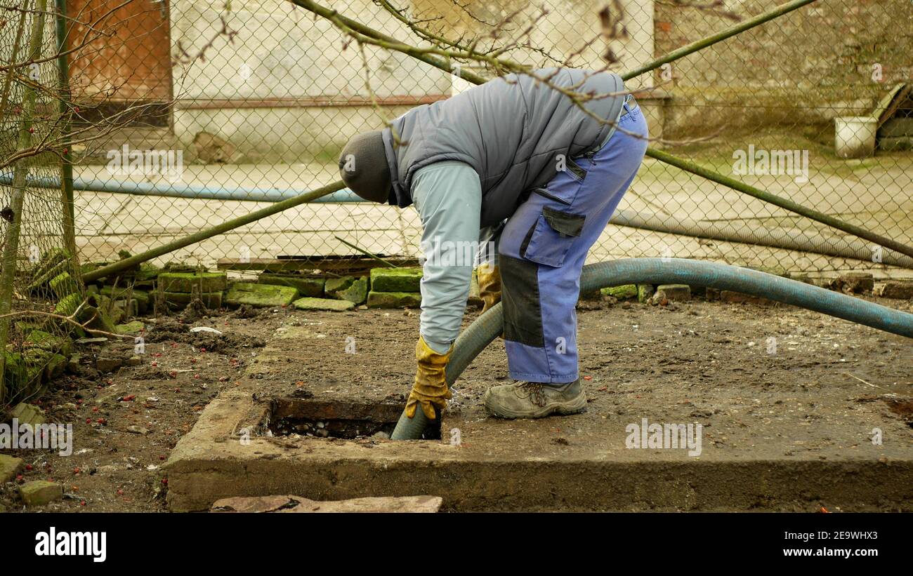 Septic cesspool pumping into tank by suction hose under high pressure