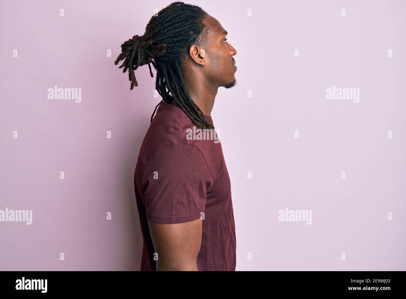 African american man with braids wearing casual clothes looking to side ...