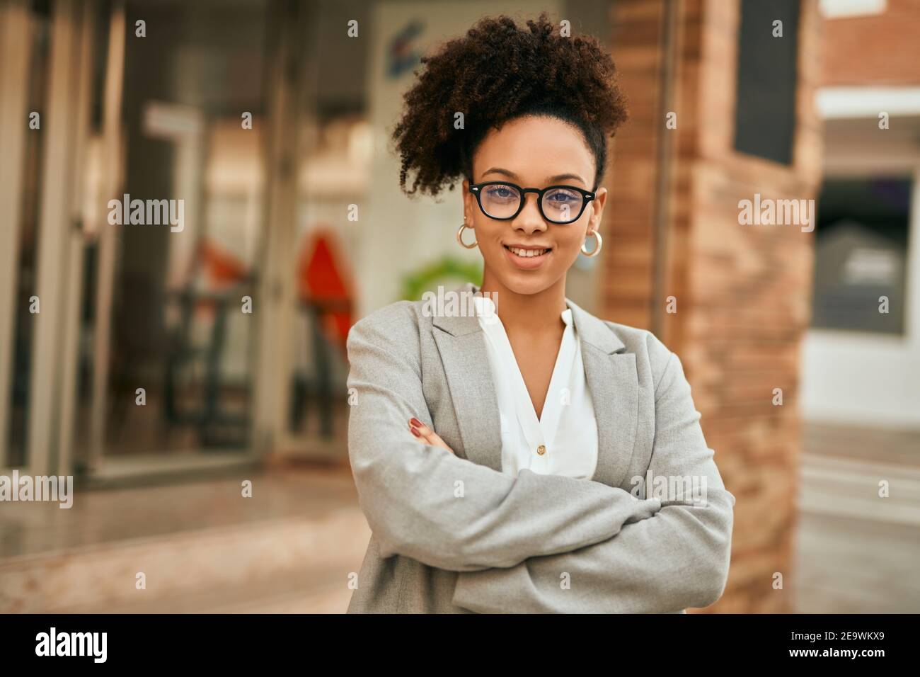 Young african american businesswoman with arms crossed standing at the ...