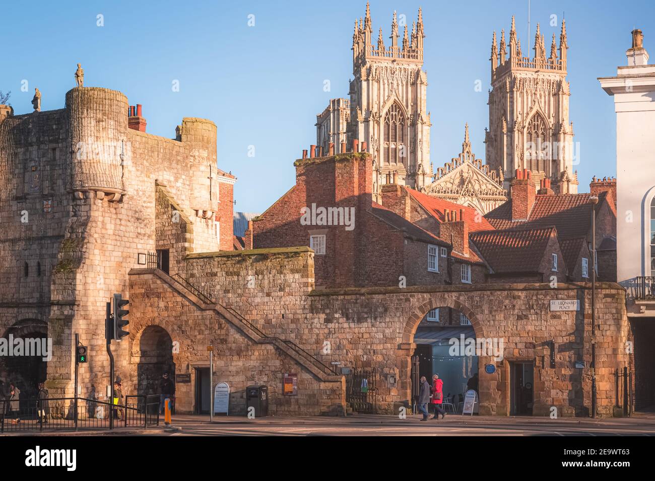 York, England - February 25 2018: Afternoon golden light on the historic old town of York and ancient city walls at St. Leonard's Place looking toward Stock Photo