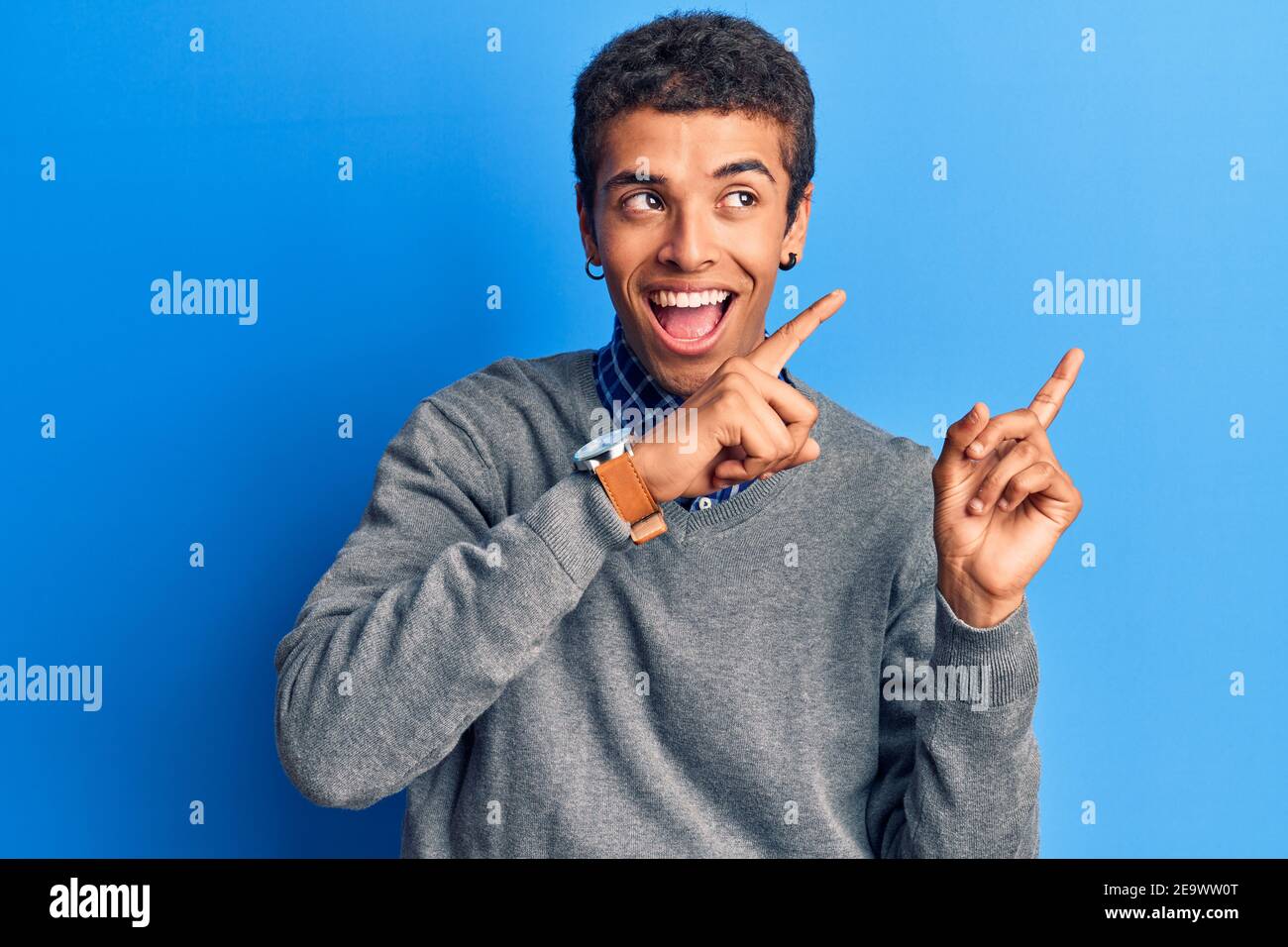 Young african amercian man wearing casual clothes smiling and looking ...