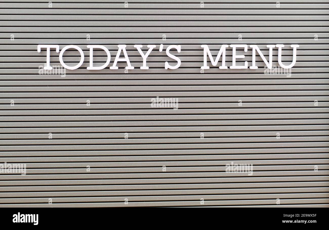 Today's menu written with white plastic letters on grey board with copy
