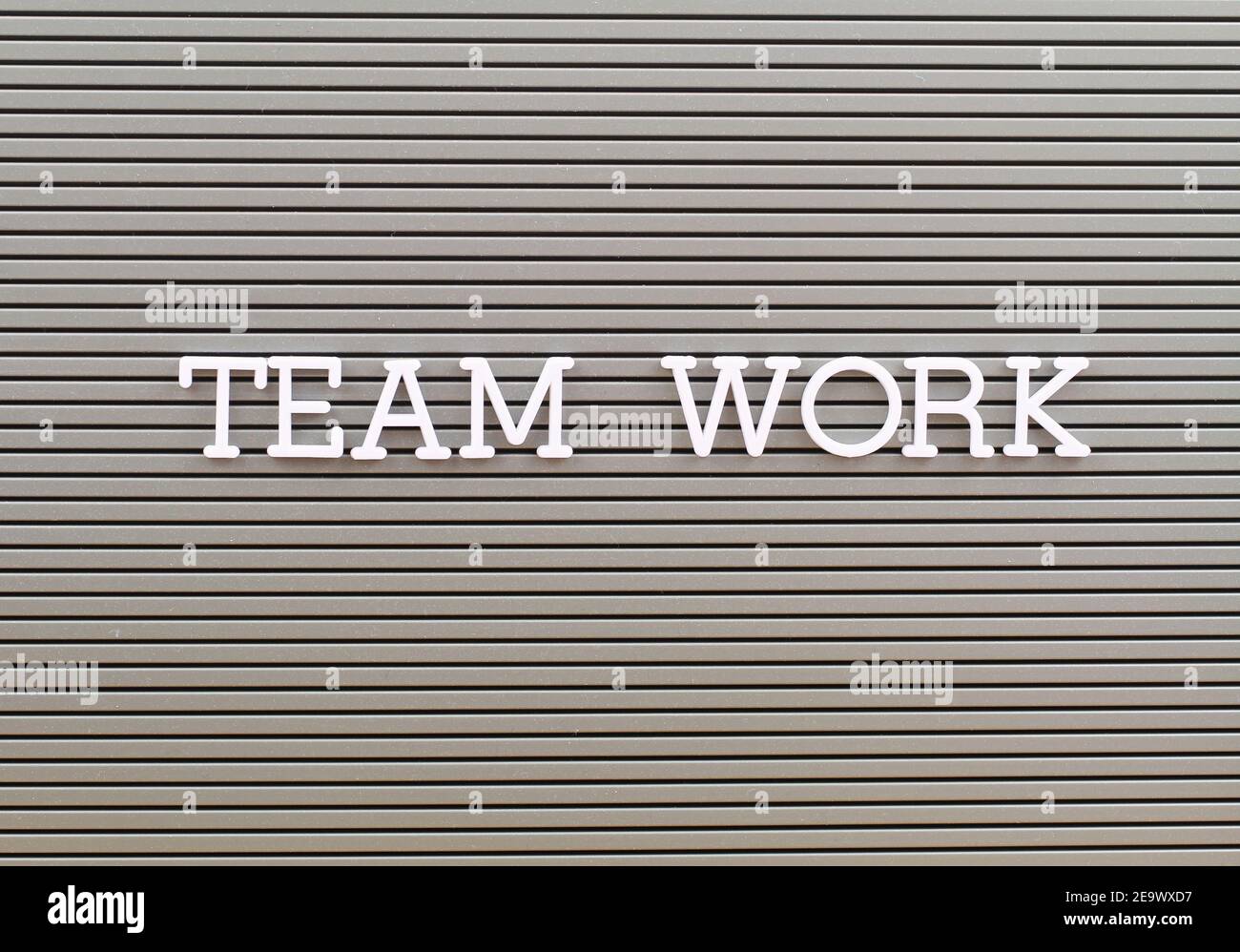 Team work written with white plastic letters on grey board Stock Photo