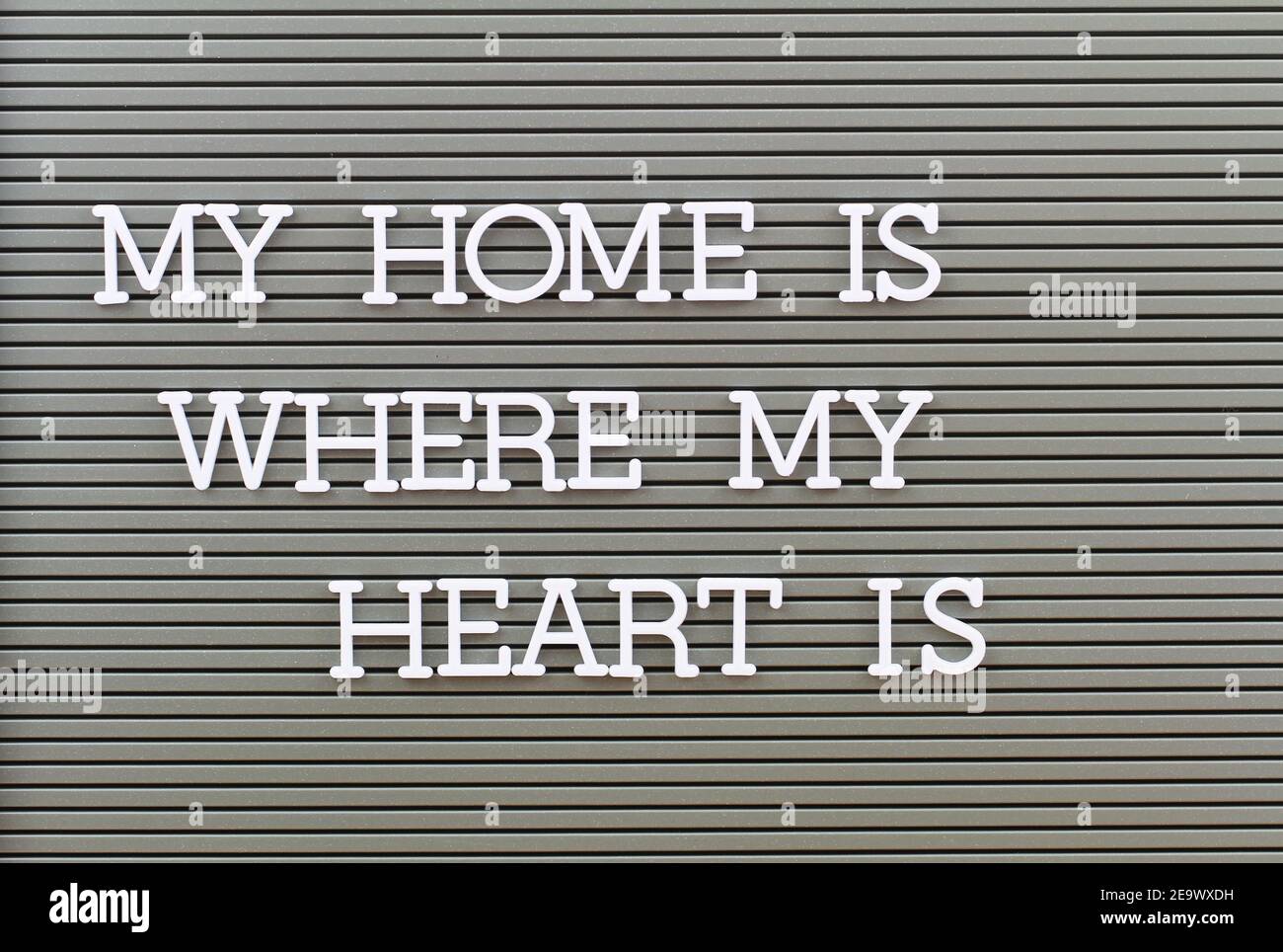 My home is where my heart is written with plastic letters on grey board