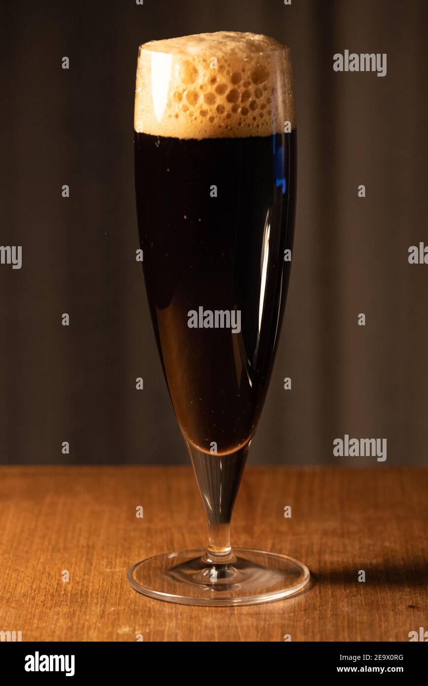 A glass of delicious craft beer served on an authentic beer glass, to be used as a background. Stock Photo