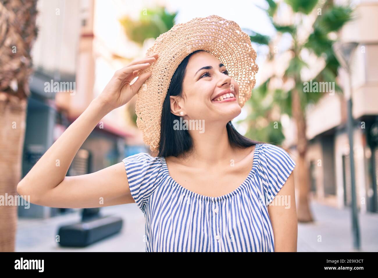 Young latin tourist girl on vacation smiling happy at the city Stock ...