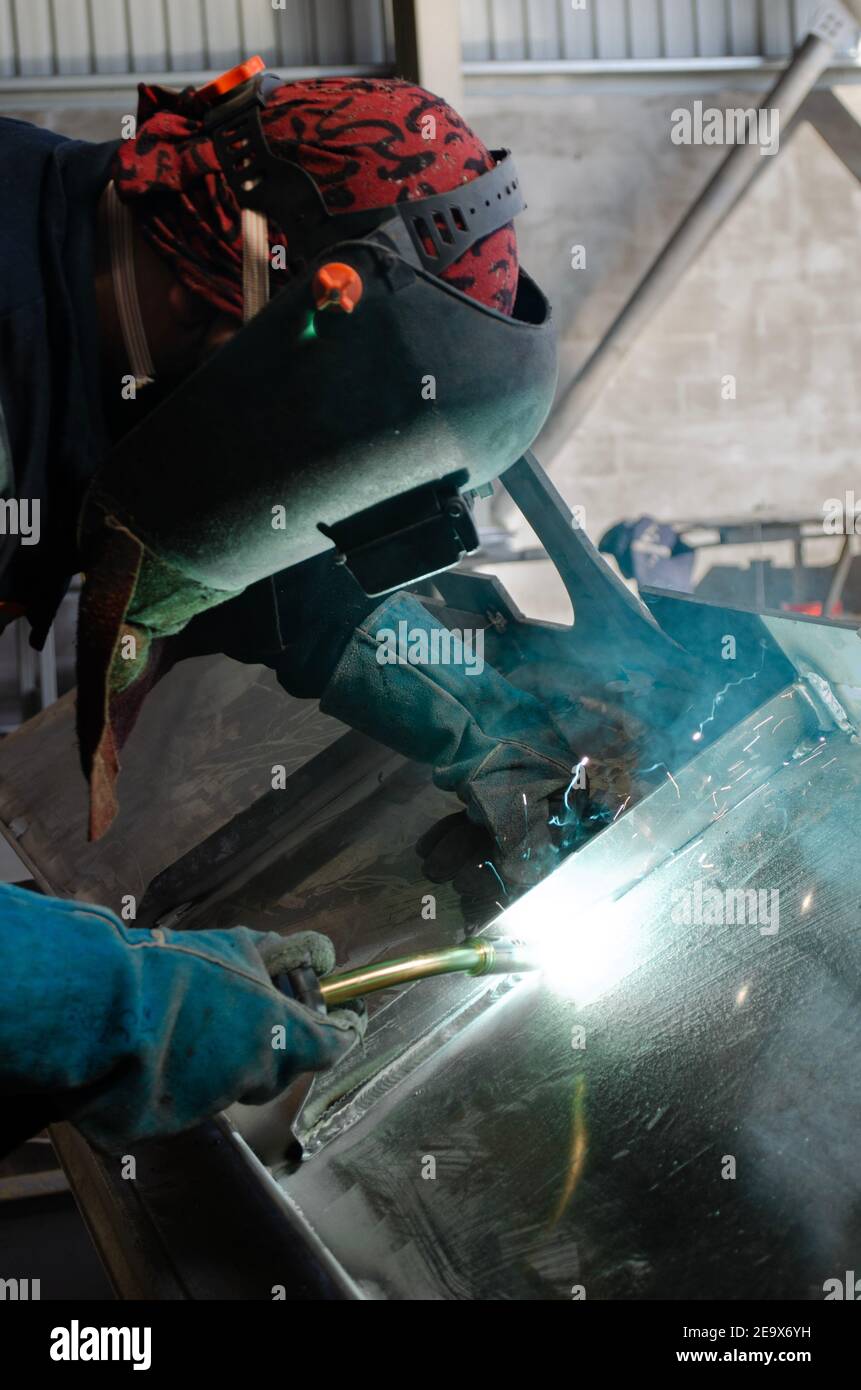 Welding worker doing nice aluminium welding with gas torch Stock Photo