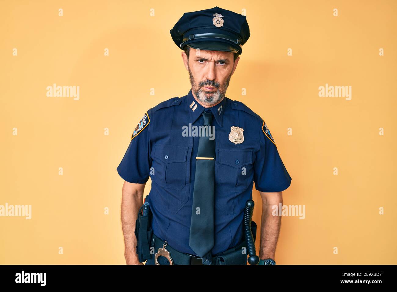 Middle age hispanic man wearing police uniform depressed and worry for distress, crying angry and afraid. sad expression. Stock Photo