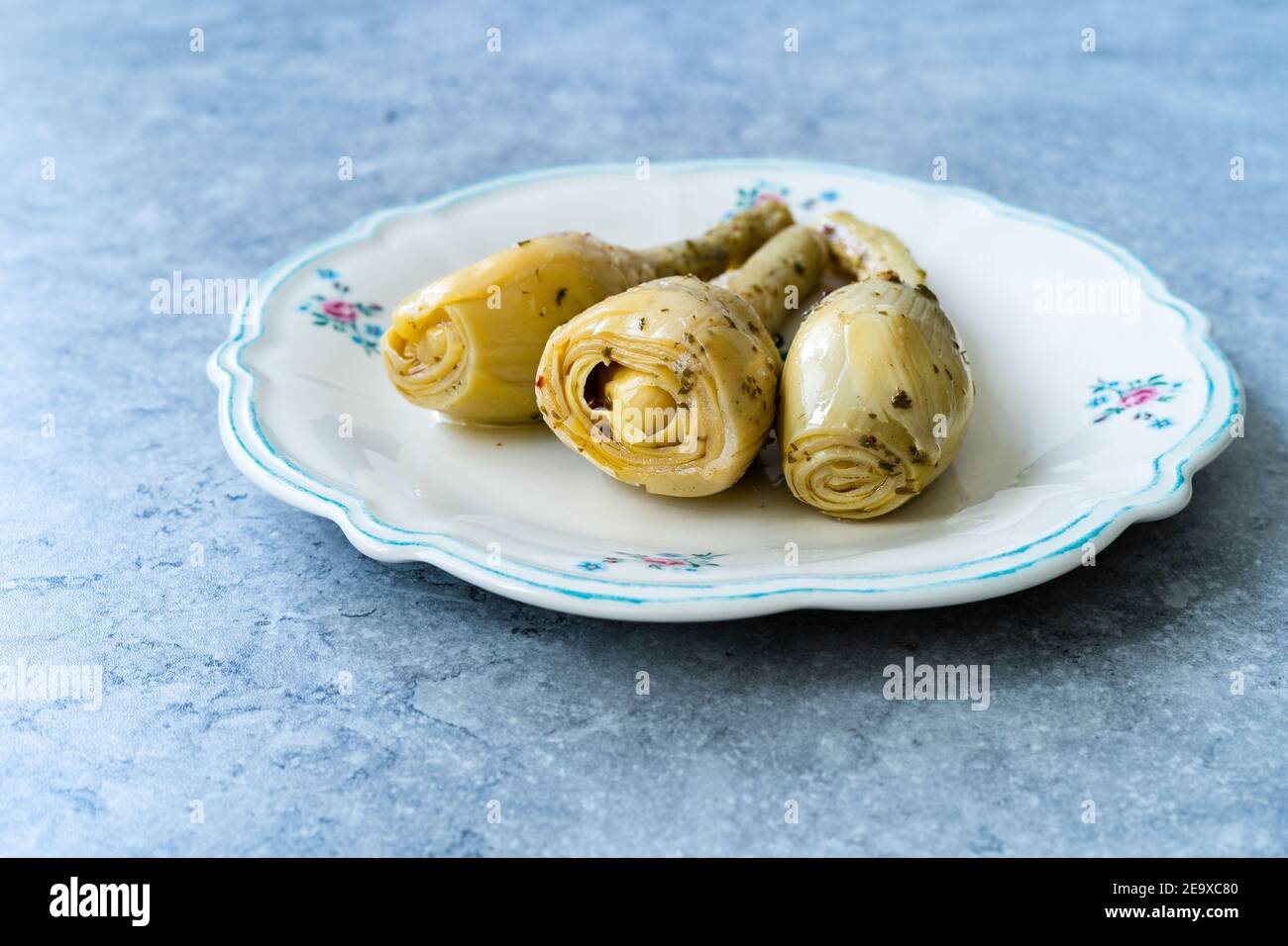 Marinated Spicy Artichoke Hearts in Olive Oil served with Root. Ready