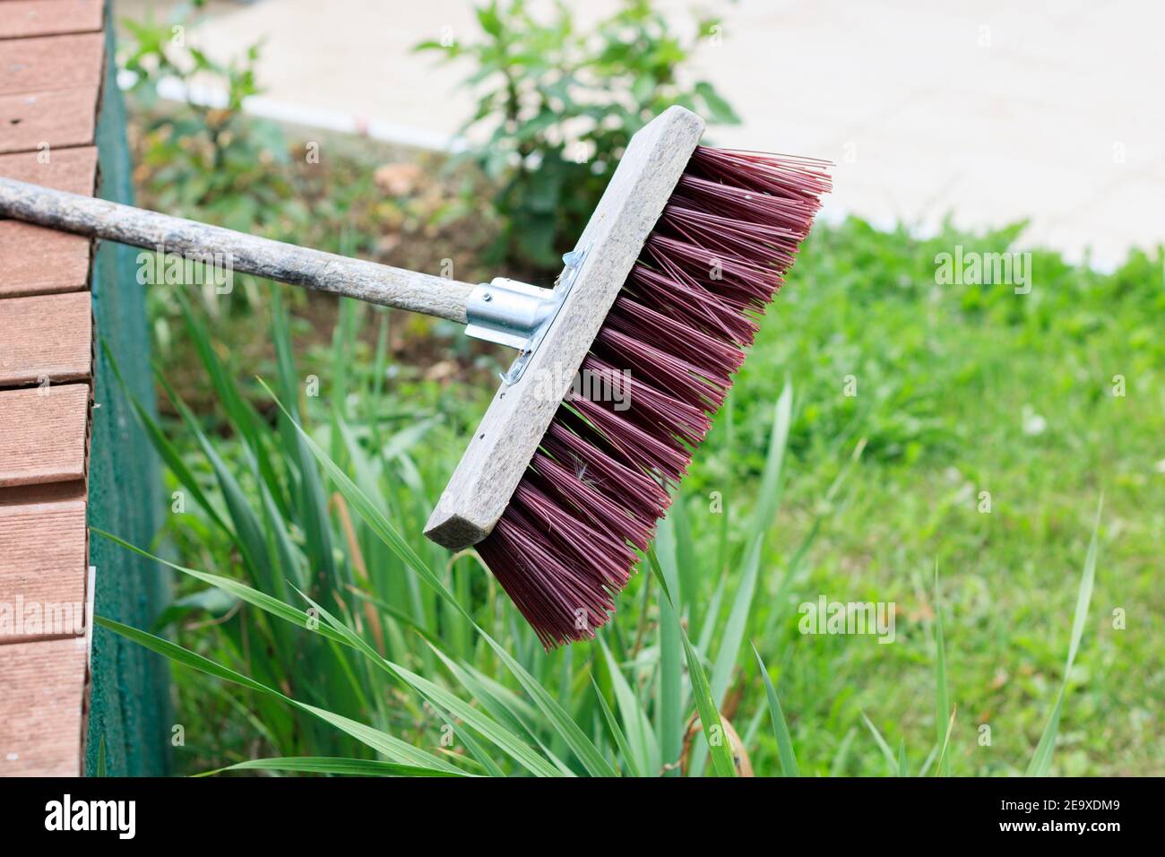 Closeup shot of a garden broom with a wooden handle Stock Photo
