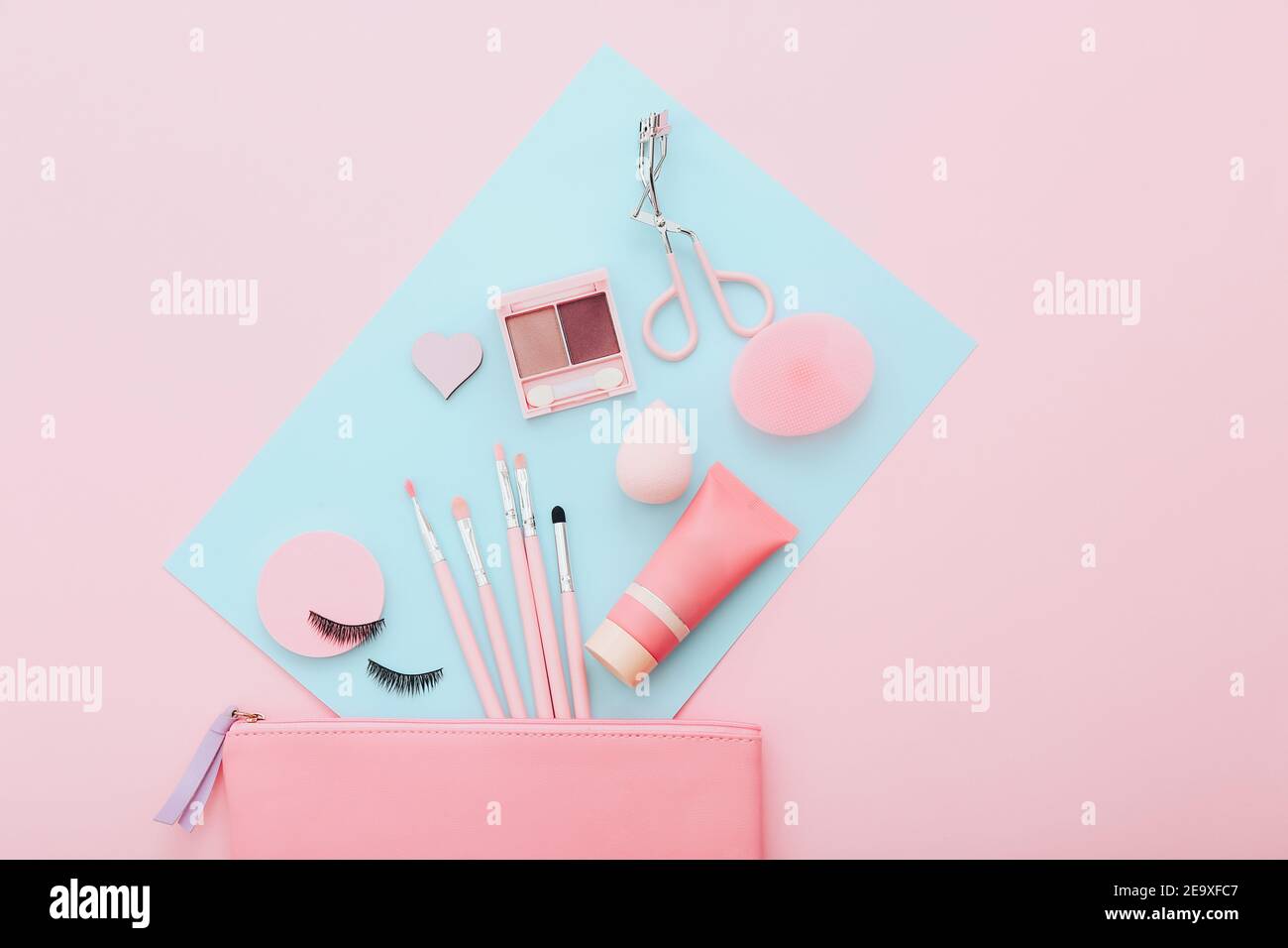 Makeup tools and accessories on blue and pink background. Beauty concept. Flat lay composition, top view Stock Photo