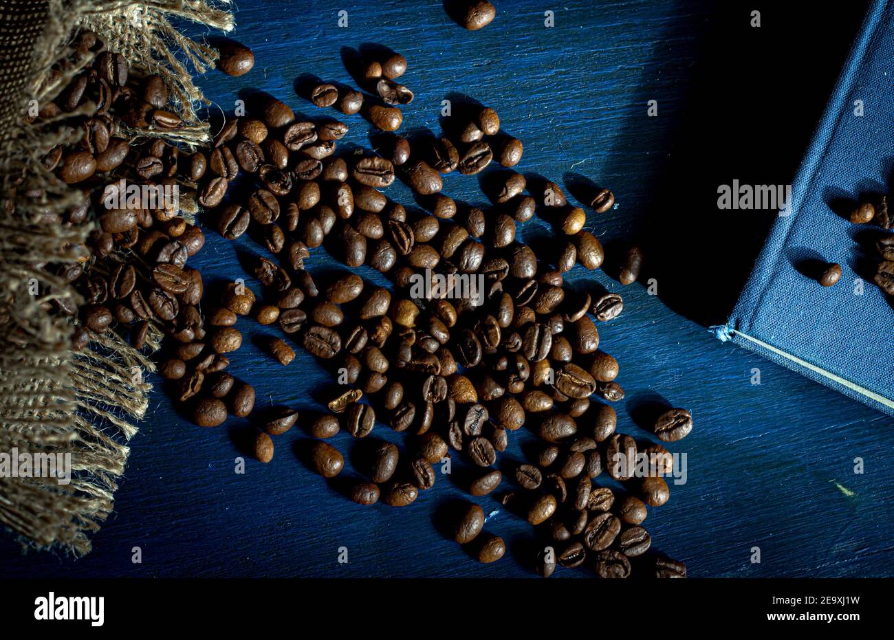 Roasted coffee beans on a navy blue background Stock Photo - Alamy